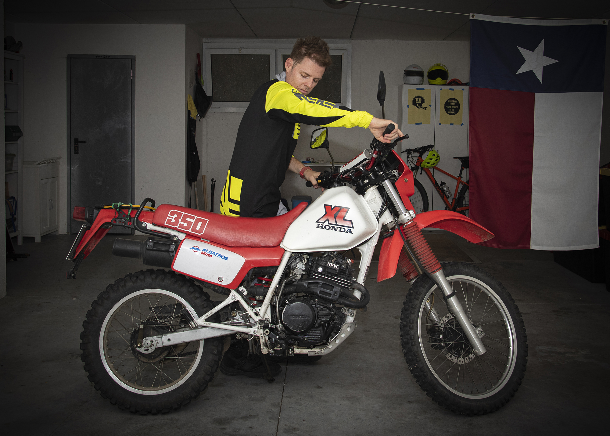 Jarred Elrod in his garage with a 1988 Honda XL350 in Italy.